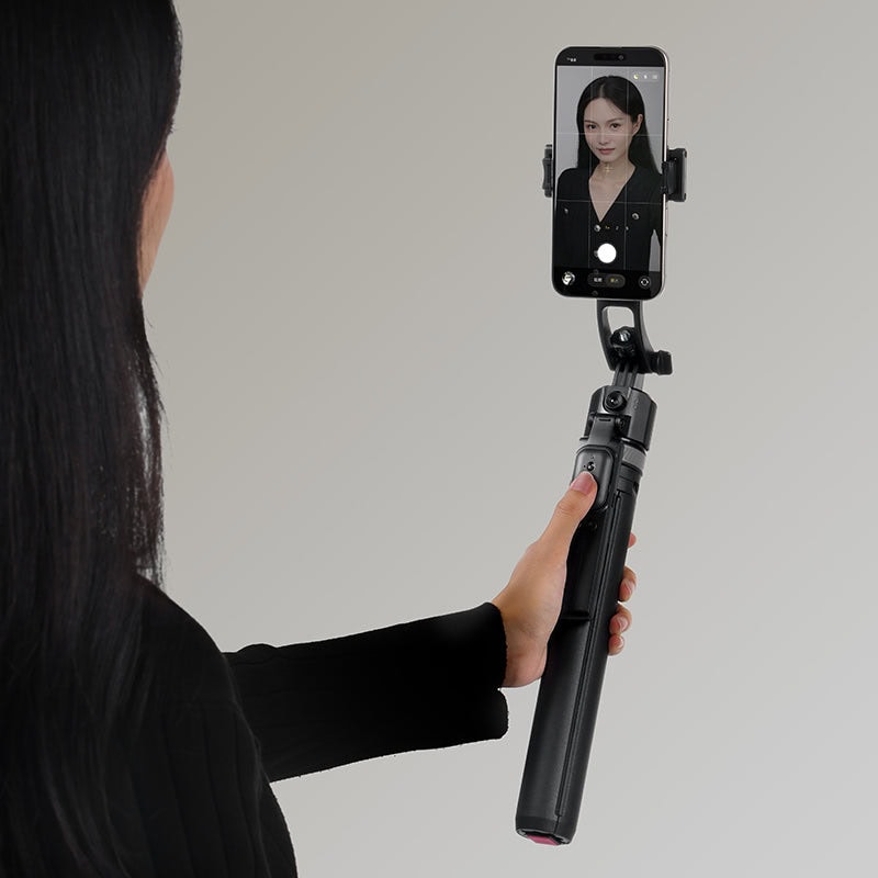 Tracking selfie stick with tripod for smartphones, featuring intelligent face tracking and stable support for hands-free photos and videos.